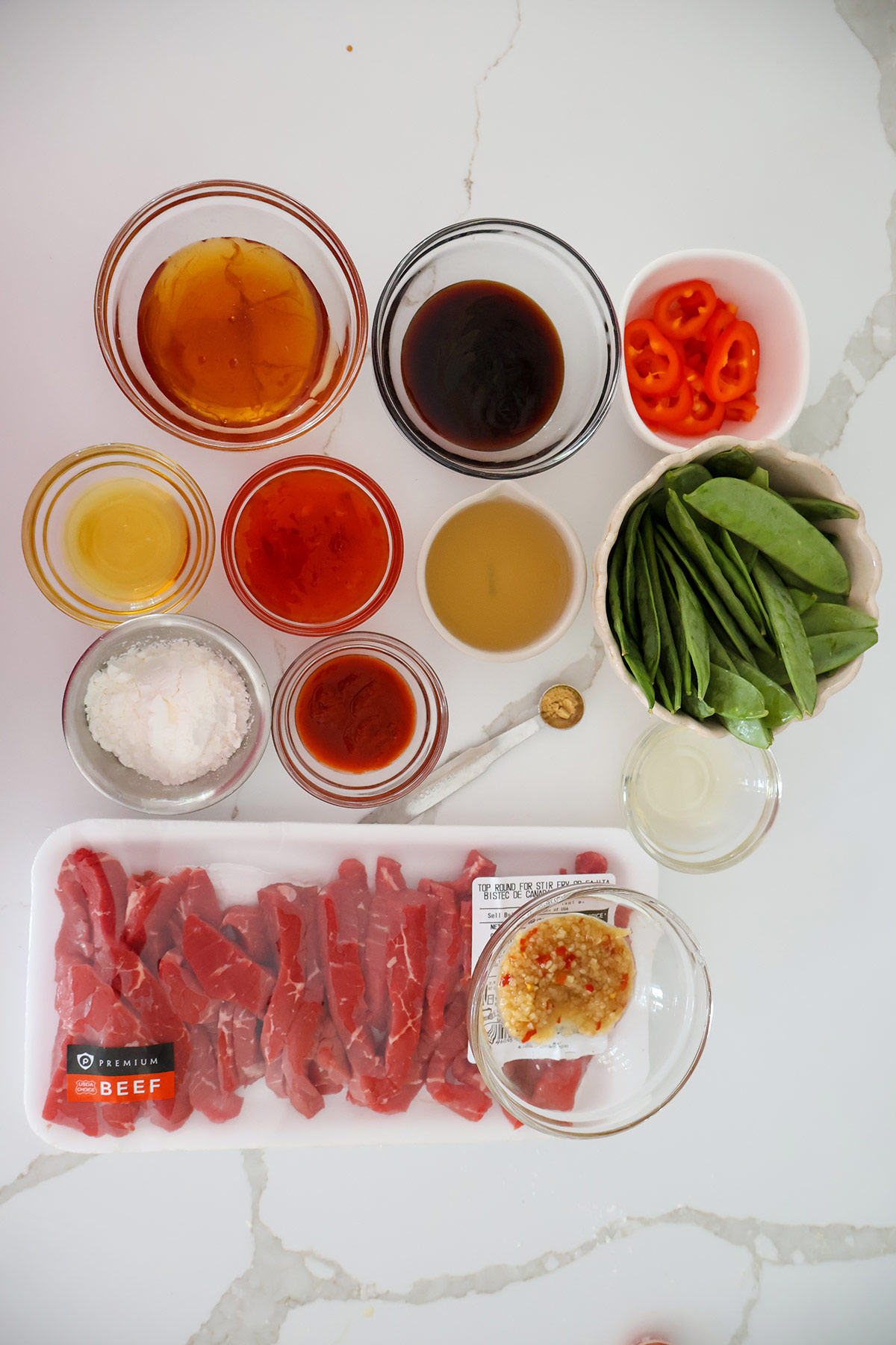 Overhead shot of beef ingredients in individual bowls