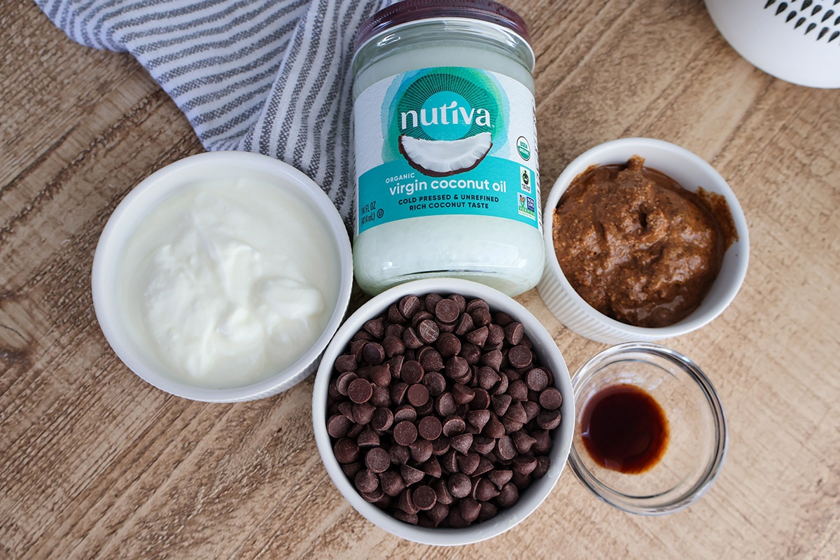 Overhead shot of chocolate chips, yogurt, almond butter, and coconut oil