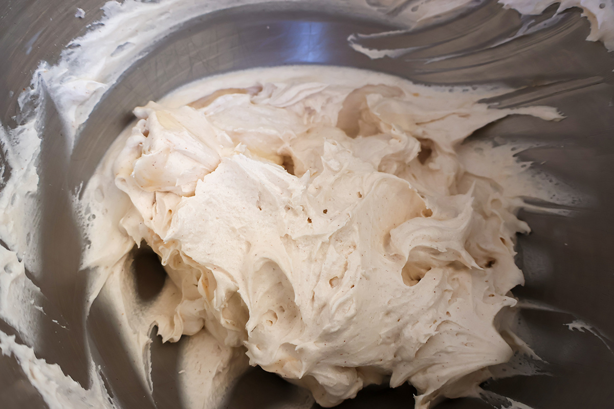 Mixing bowl full of cinnamon cream cheese frosting.