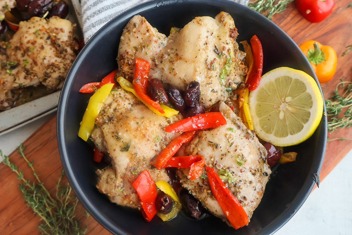Overhead shot of plateful of chicken thighs with vegetables.
