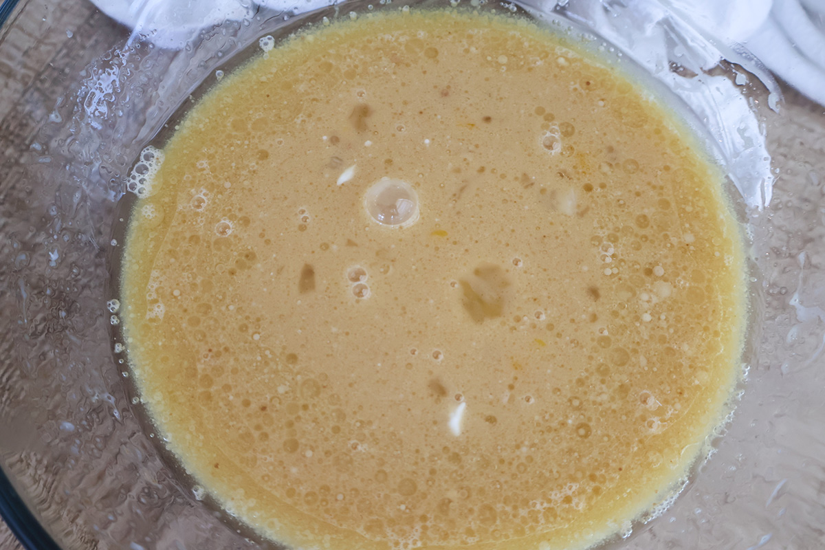 An overhead shot of the wet muffin ingredients mixed in a bowl.