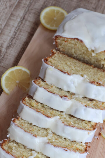 An overhead shot of sliced lemon pound cake on a cutting board.