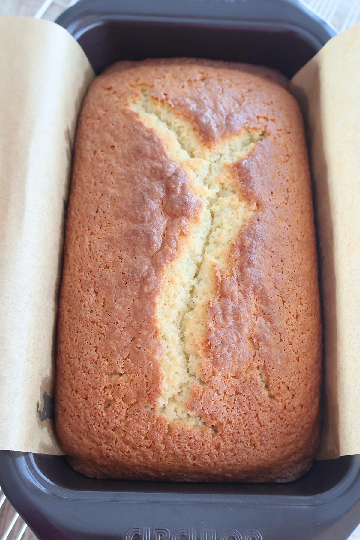An overhead shot of baked lemon pound cake in a loaf pan. 