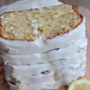 Stack of slices of frosted lemon pound cake.