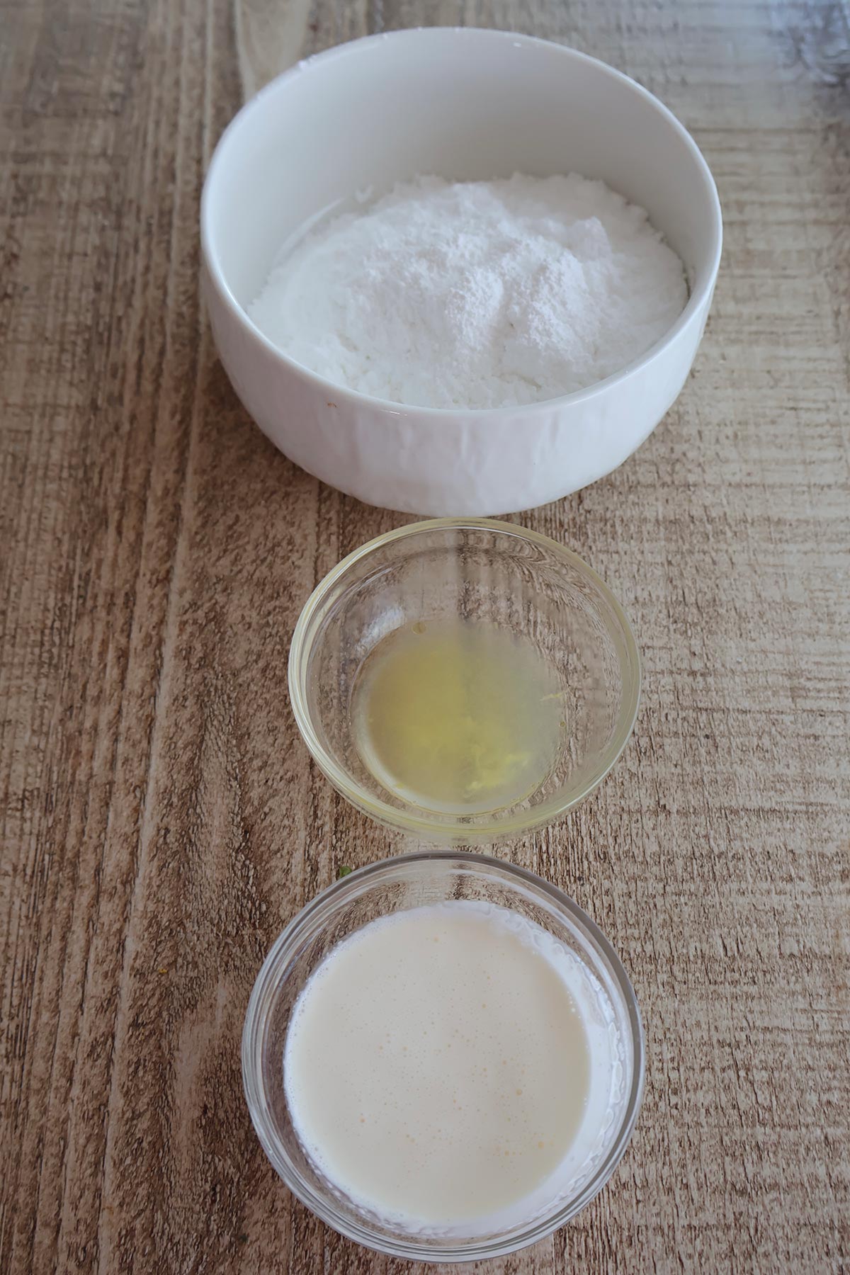 An overhead shot of lemon frosting ingredients in individual bowls. 