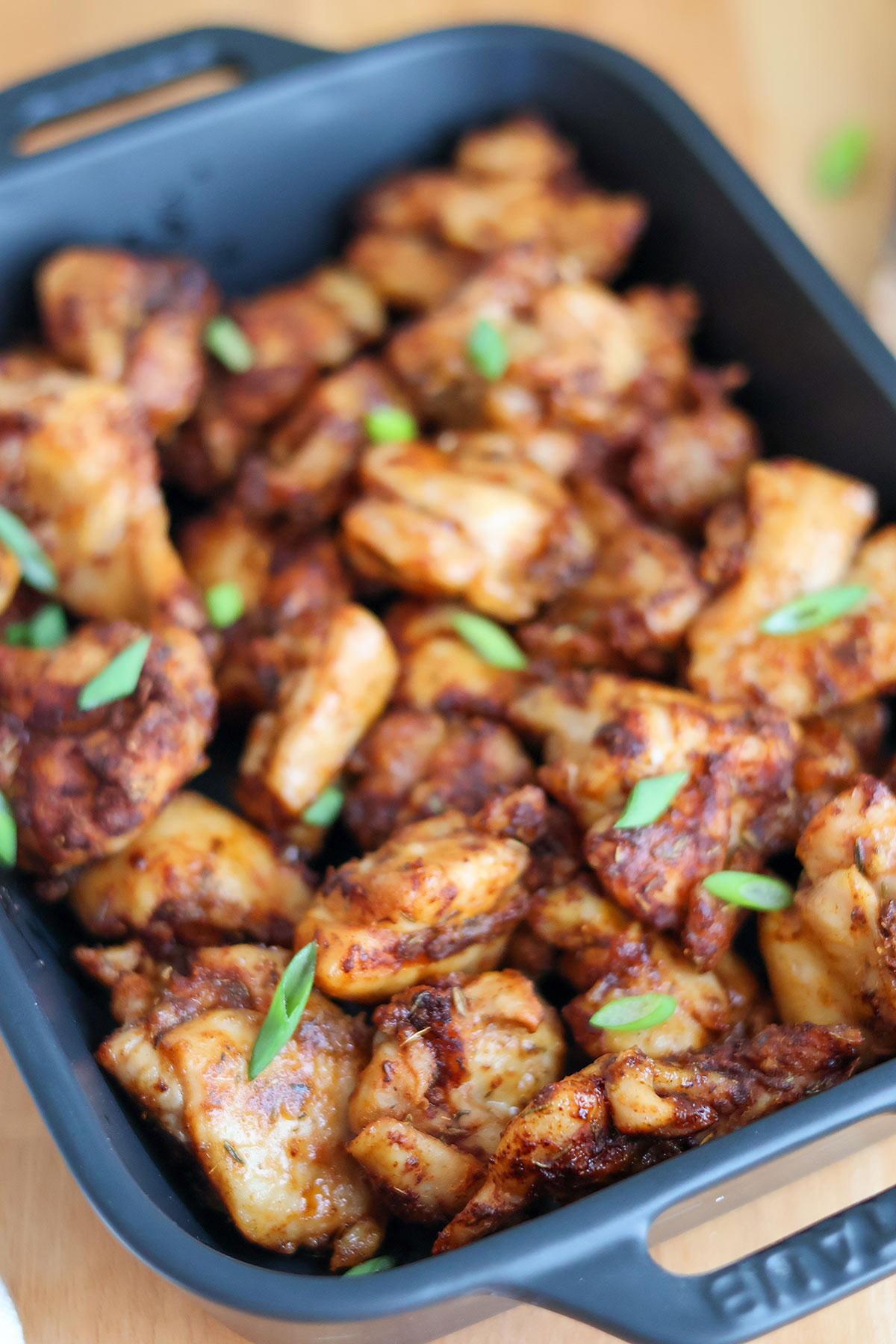 Golden air-fried chicken bites in a blue baking dish.