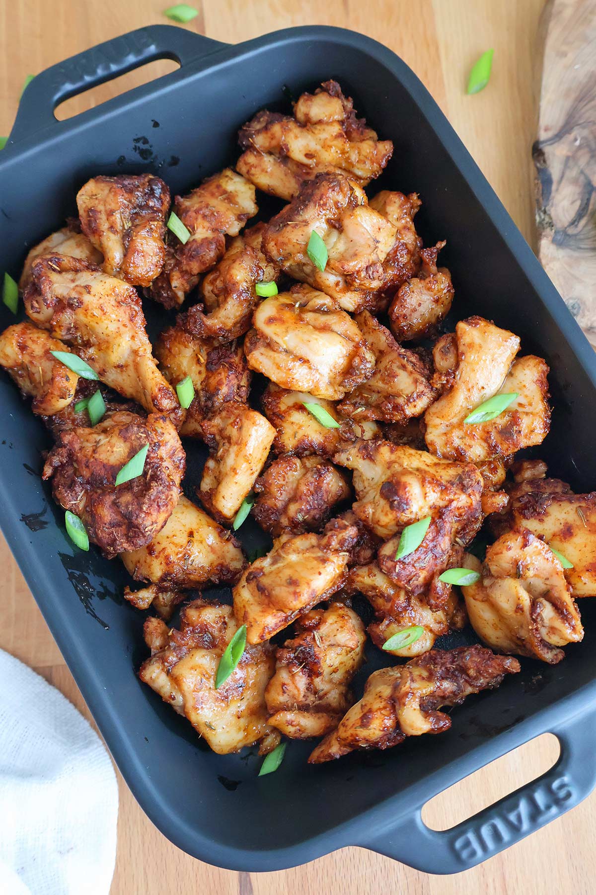 Golden air-fried chicken bites in an air fryer basket.