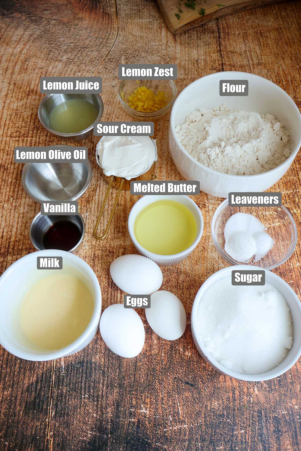 Lemon loaf cake ingredients in individual bowls.