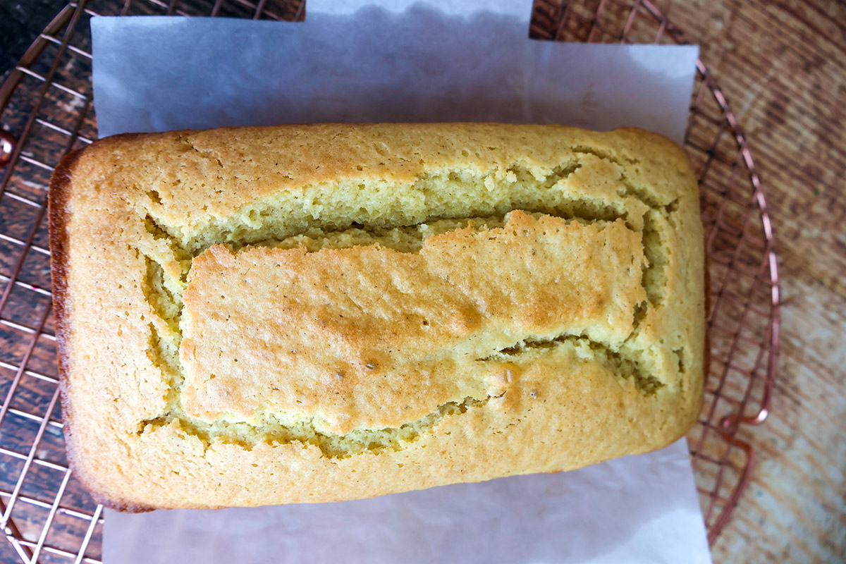 Unfrosted lemon loaf cake on a wooden board.