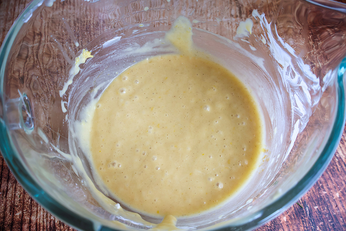 Wet loaf cake ingredients in a glass bowl. 