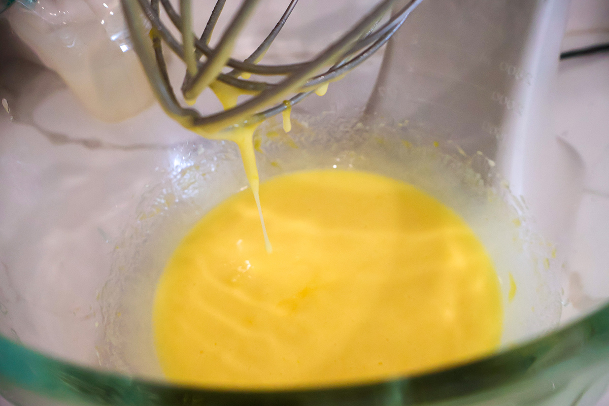 Whisked eggs in a glass bowl. 