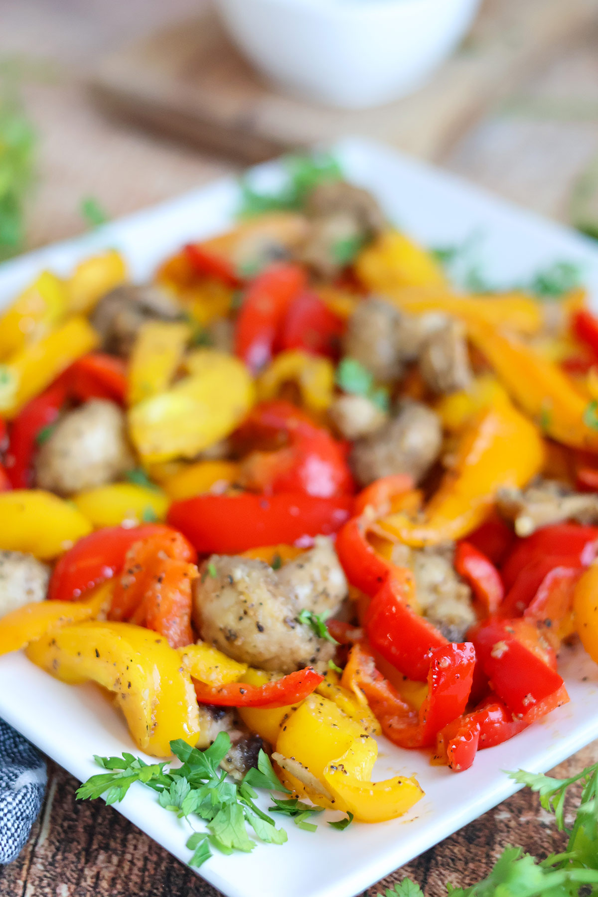 Cooked mushrooms and bell pepper strips on a white plate.