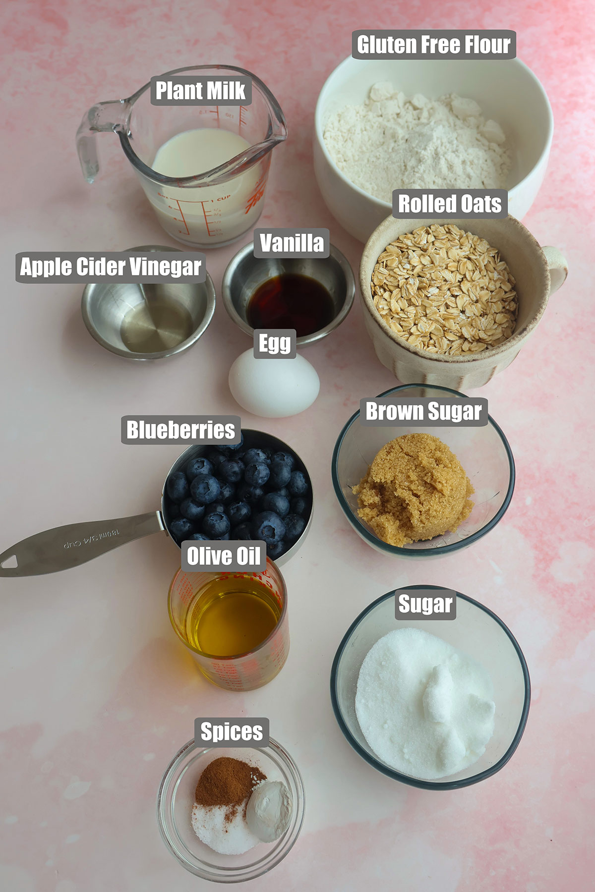 Blueberry muffin ingredients in individual bowls.
