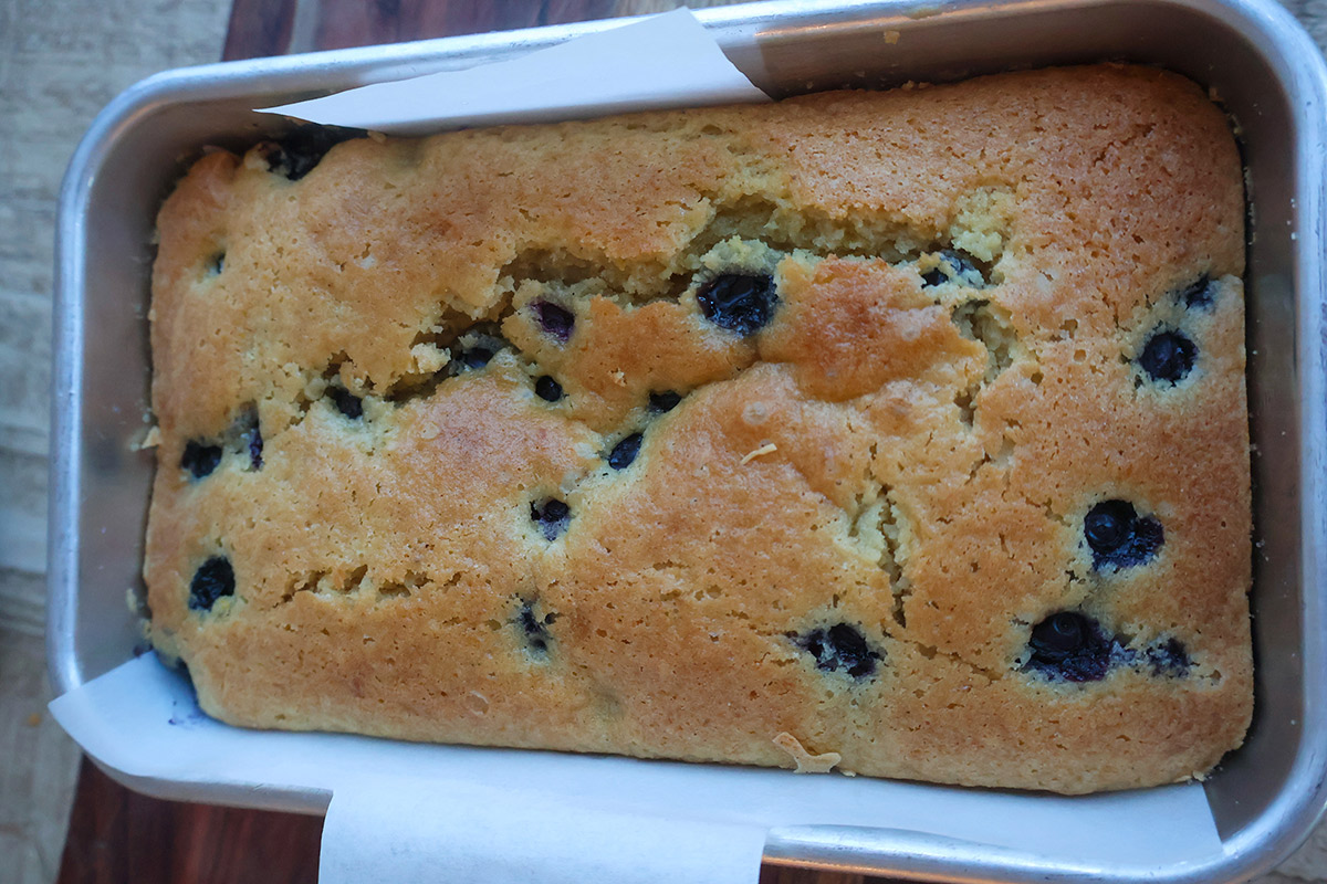 Baked blueberry lemon cake in a loaf pan.