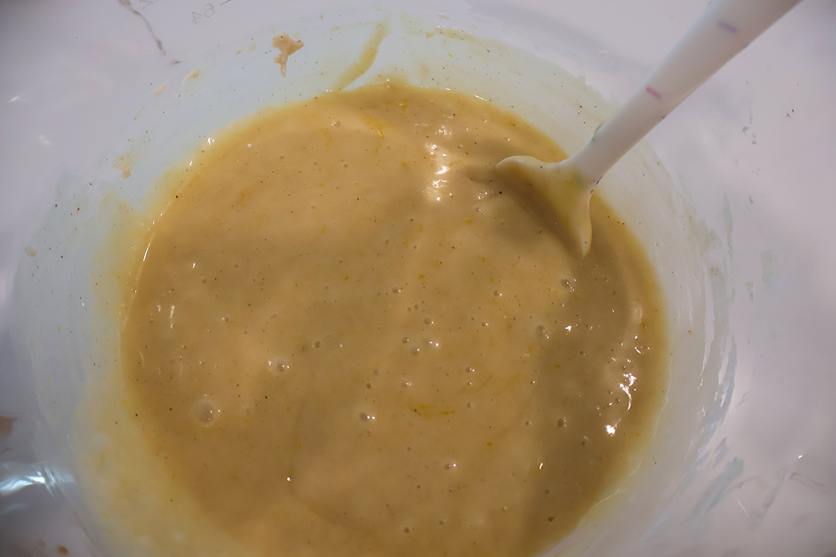 Lemon loaf batter in a glass mixing bowl. 