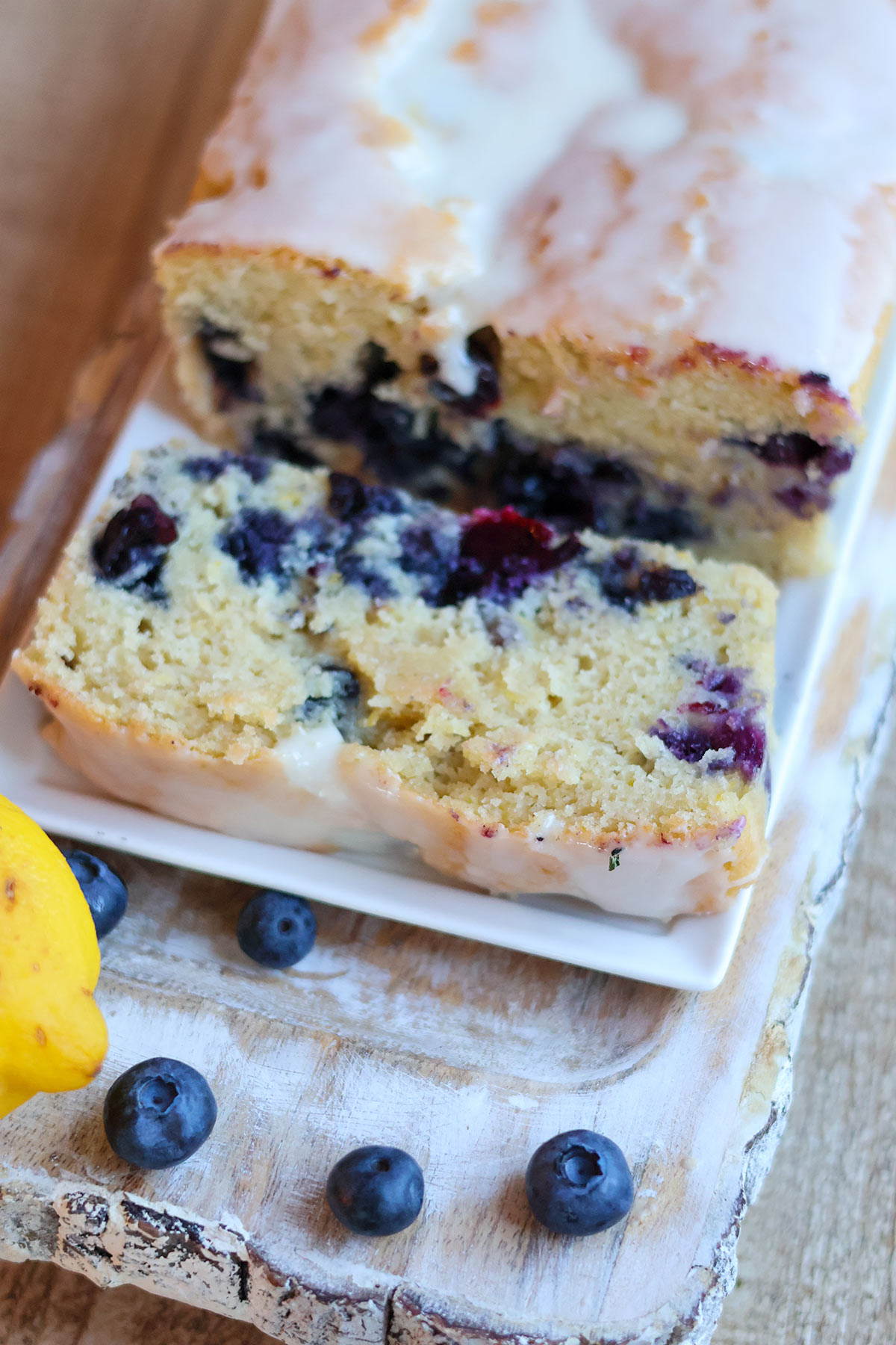 Slice of blueberry loaf cake on a white plate.