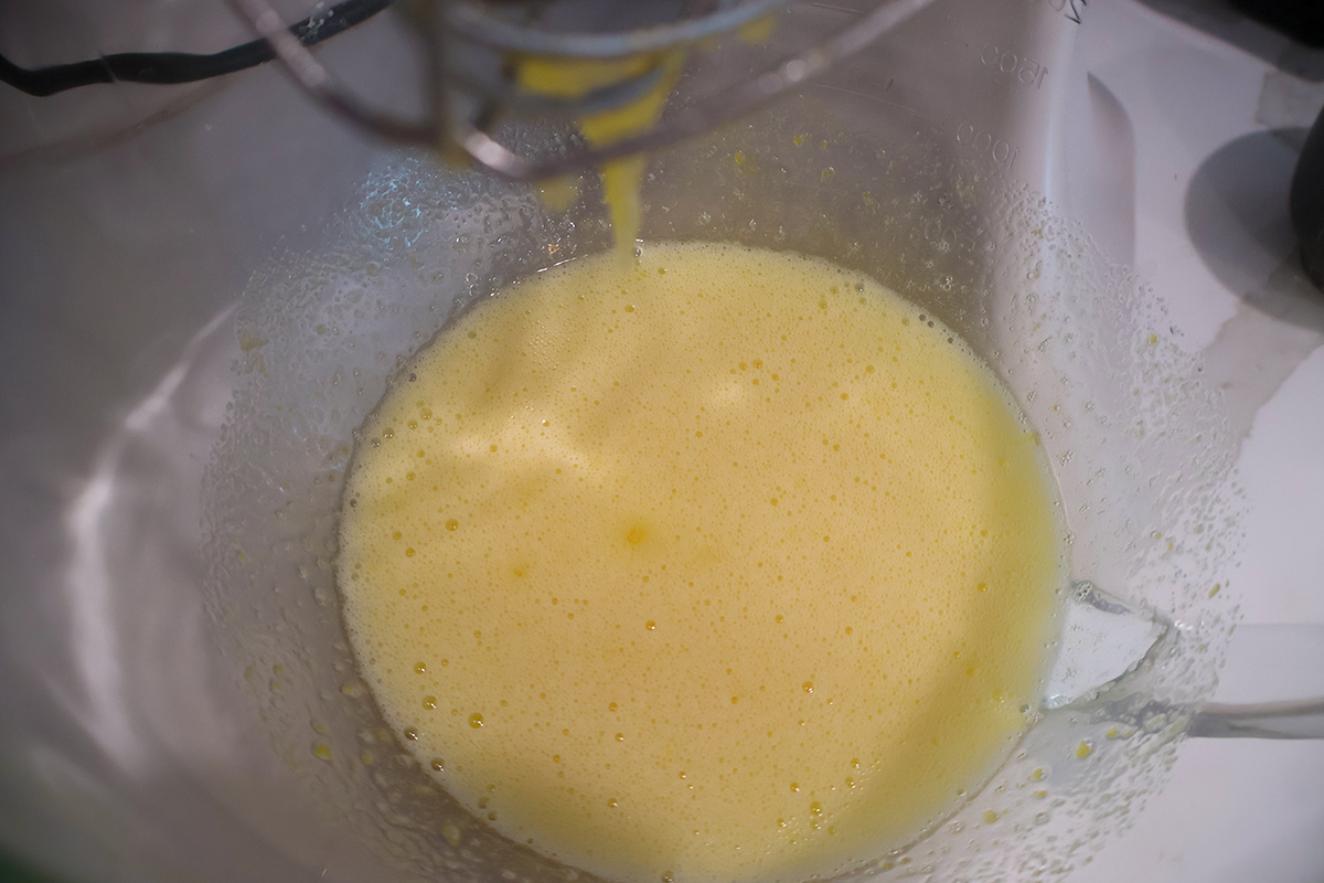 Whisked sugar and eggs in a mixing bowl.