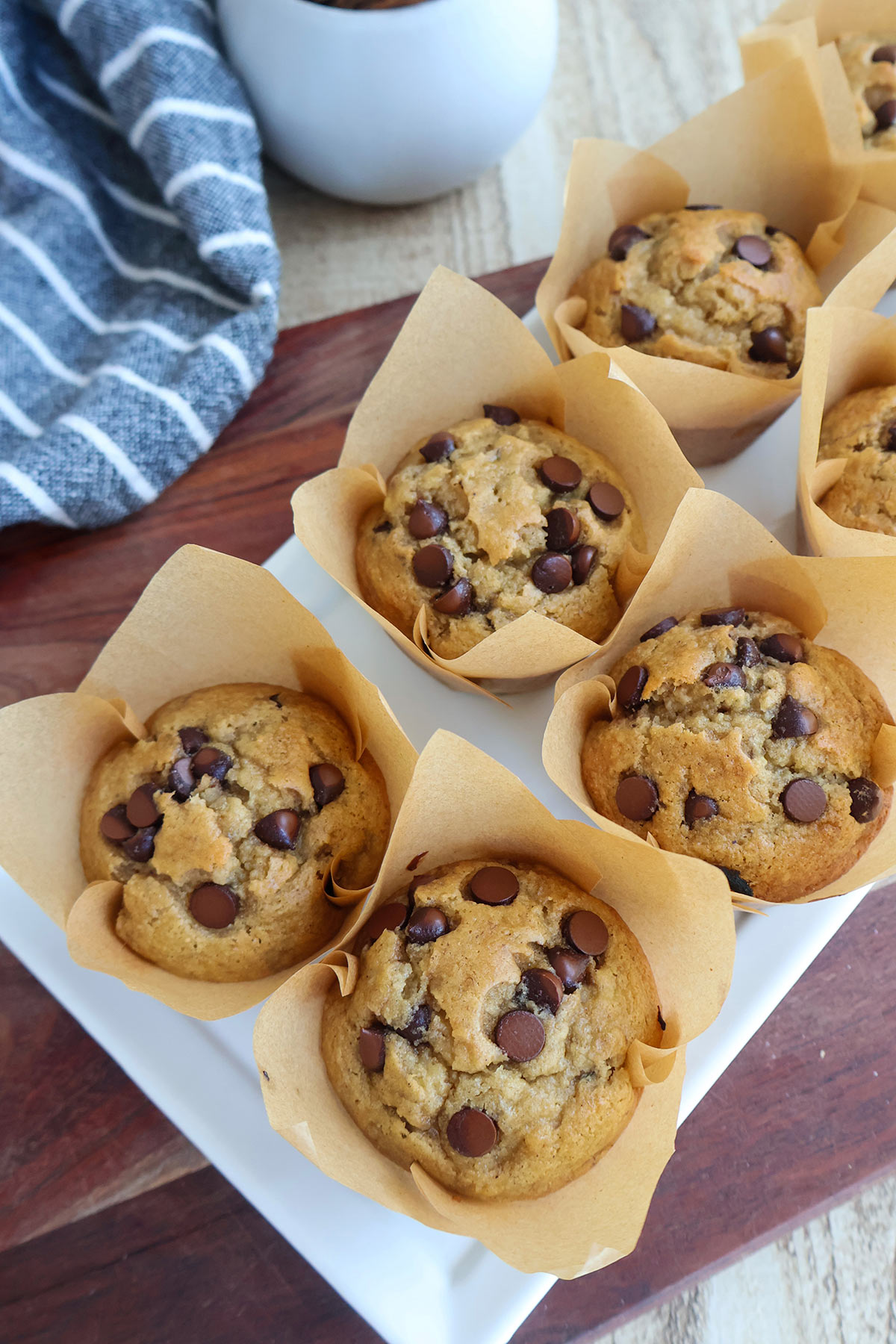Five chocolate chip banana muffins in liners.