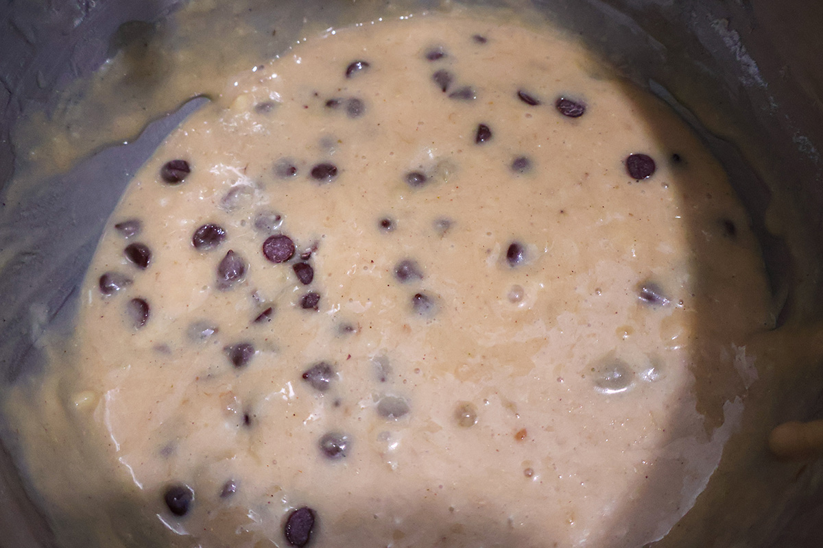A mixing bowl with chcoolate chip banana muffin batter.