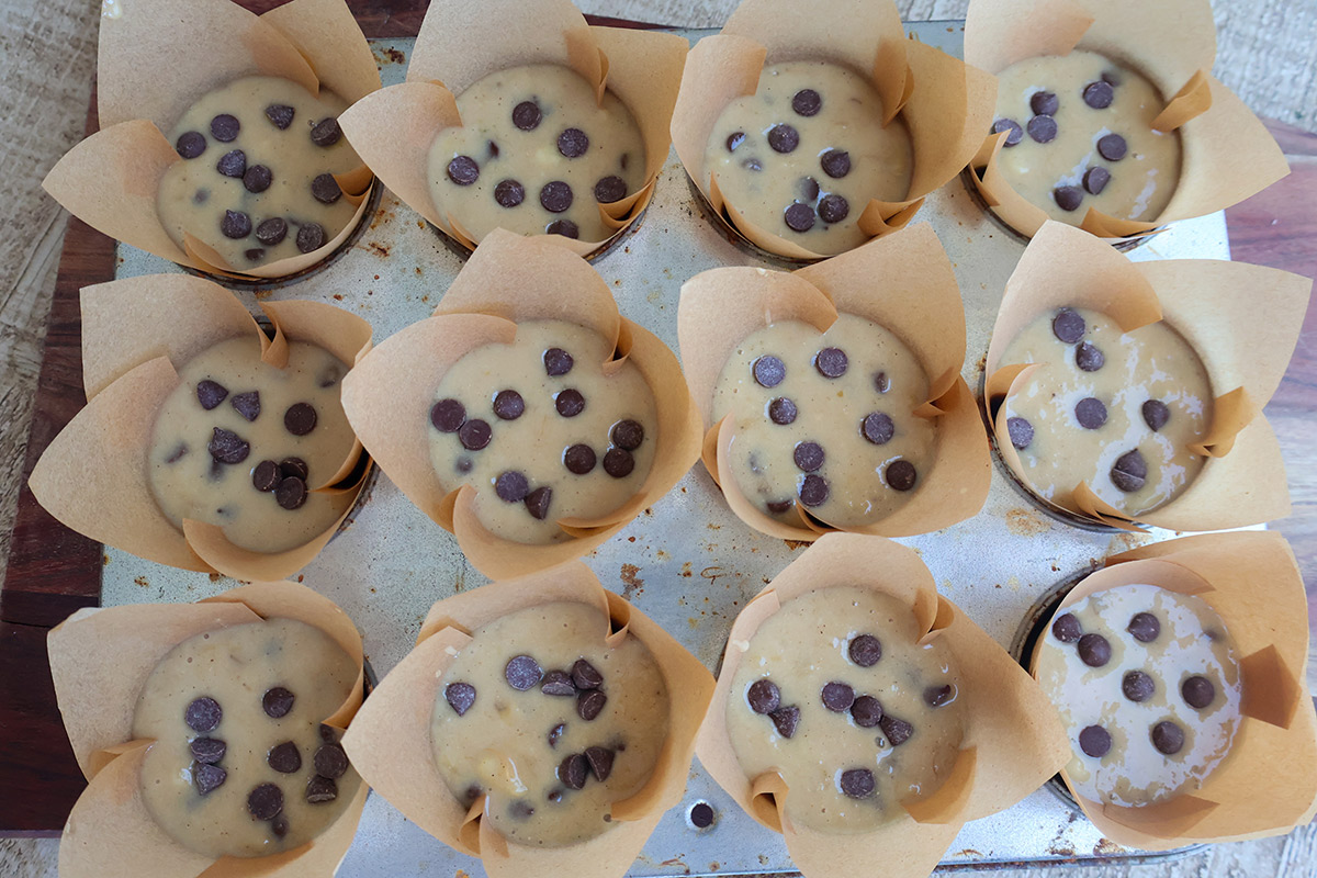 Banana muffin batter in a lined cupcan tin.