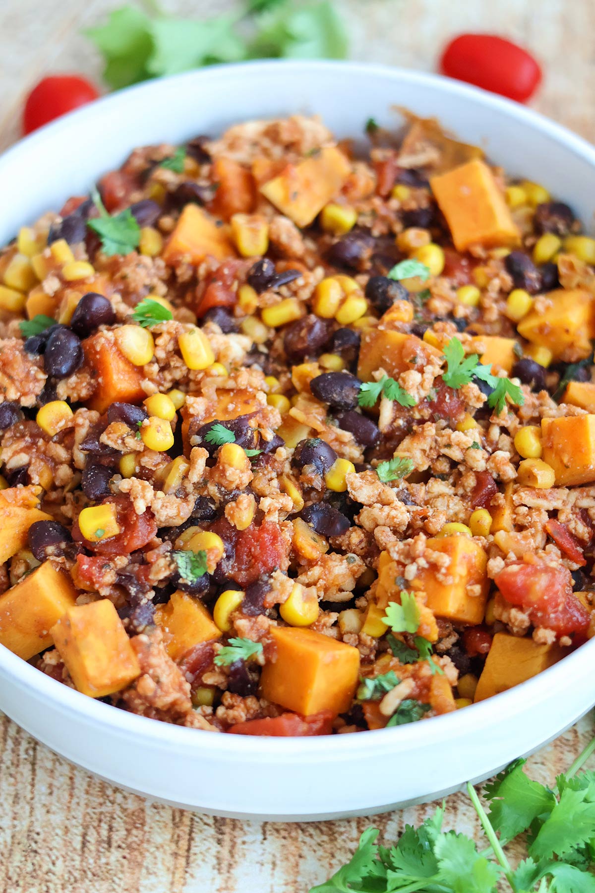 A white bolwful of Tex-Mex chicken and sweet potatoes.