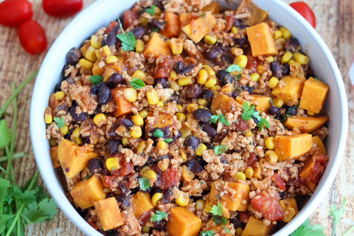 A bowlful of ground chicken, sweet potatoes, and veggies.