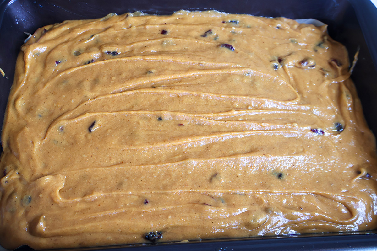 Pumpkin cake batter in a baking dish.