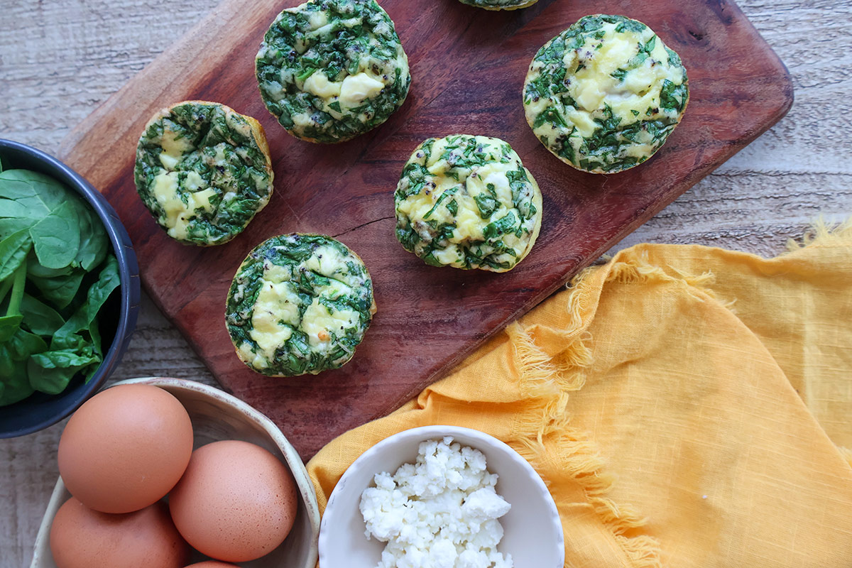 Five egg bites on a wooden board.