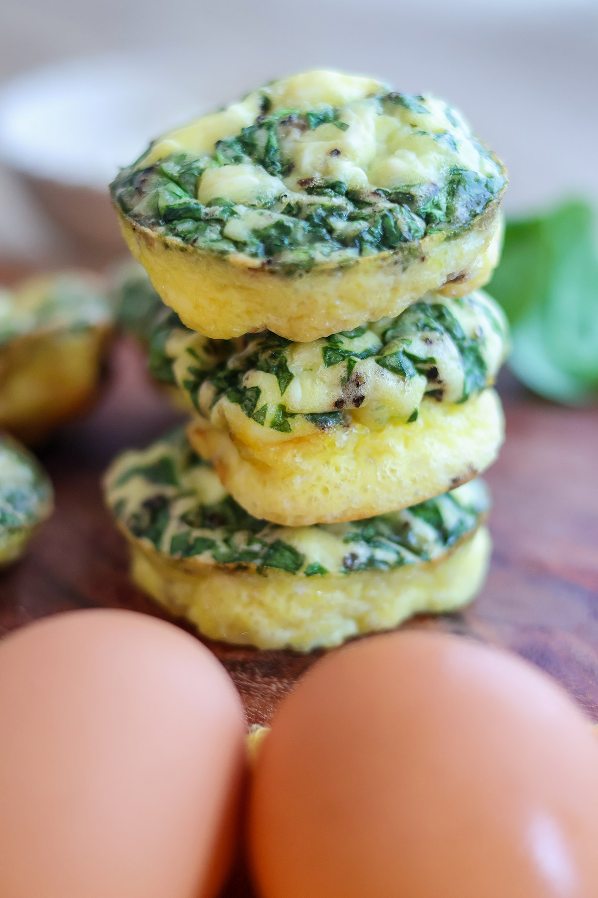 Three spinach and feta egg cups stacked atop one another.