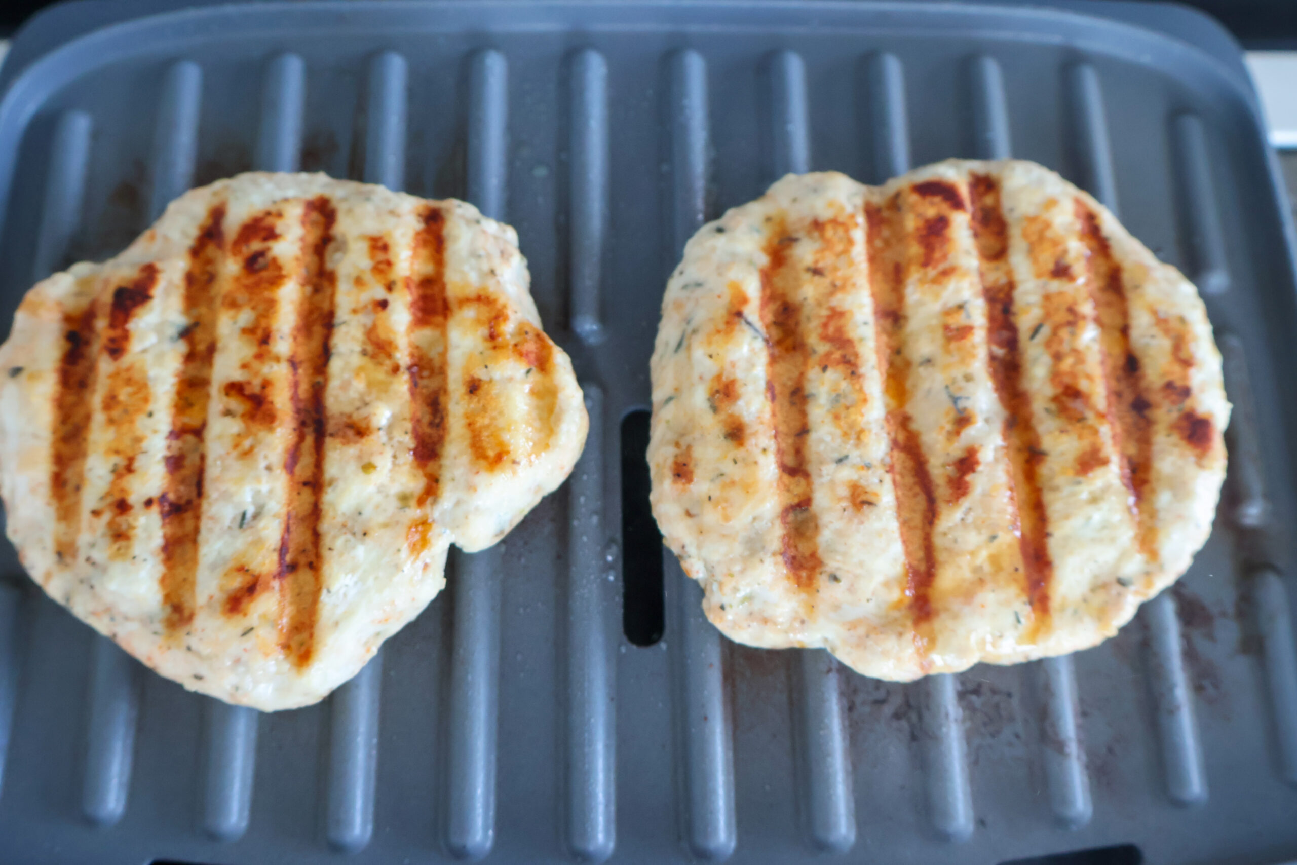 Grilled chicken burgers on a George Foreman grill.