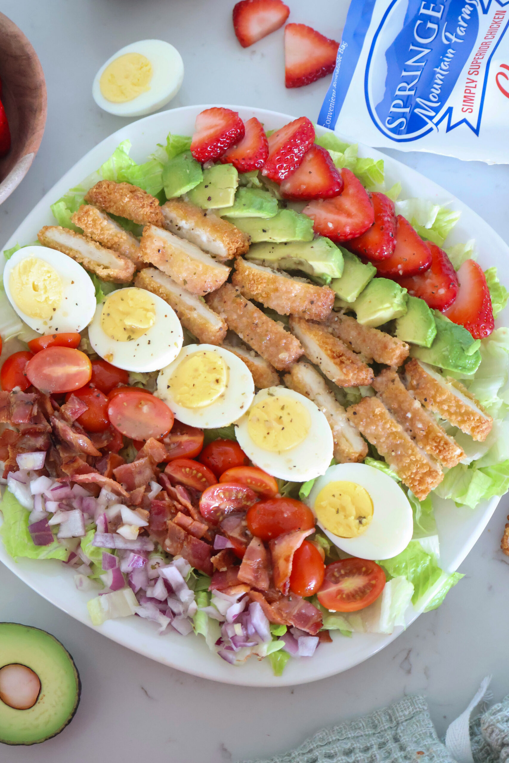 Strawberry cob salad with dressing.
